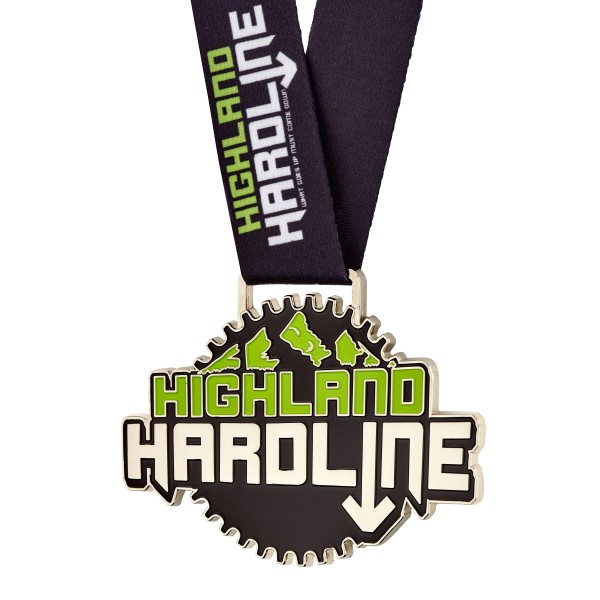 A custom medal with black background and green and white text that reads Highland Hardline.