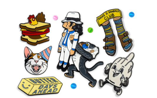 Six funny pin badges. A chicken sandwich with the chicken's head popping through the bread, Raffiki from Lion King holding up Michael Jackson like he's Simba, a cat wearing a party hat, and more.